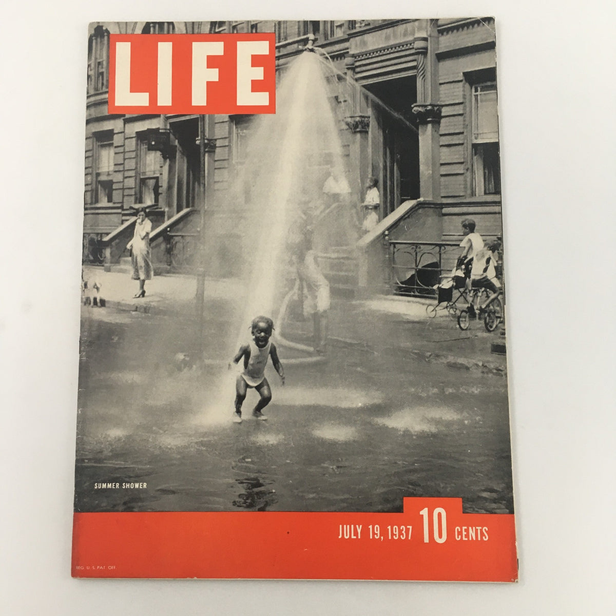 Cover of VTG Life Magazine from July 19, 1937 featuring the 'Summer Shower' article, showcasing a playful child running through water in a city setting.