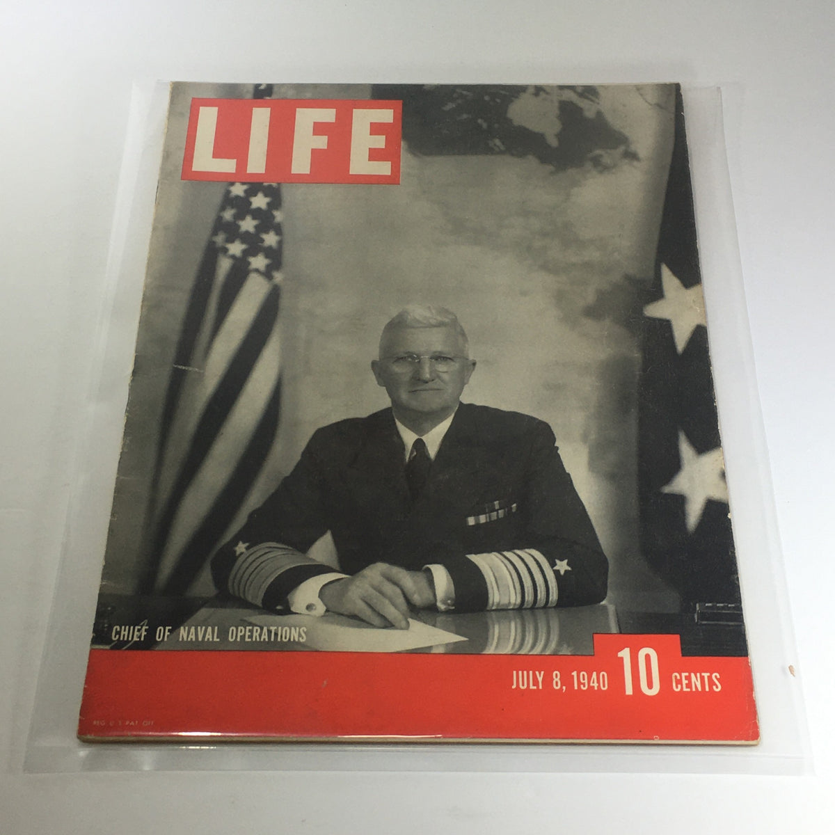 Vintage Life Magazine from July 8, 1940, featuring the Chief Naval Operations with a black and white cover showing a naval officer in uniform, set against a backdrop of American flags.