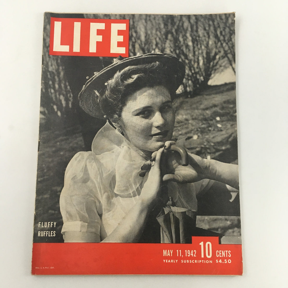Cover of VTG Life Magazine May 11 1942 featuring Fluffy Ruffles fashion and a woman in a vintage attire with an umbrella.