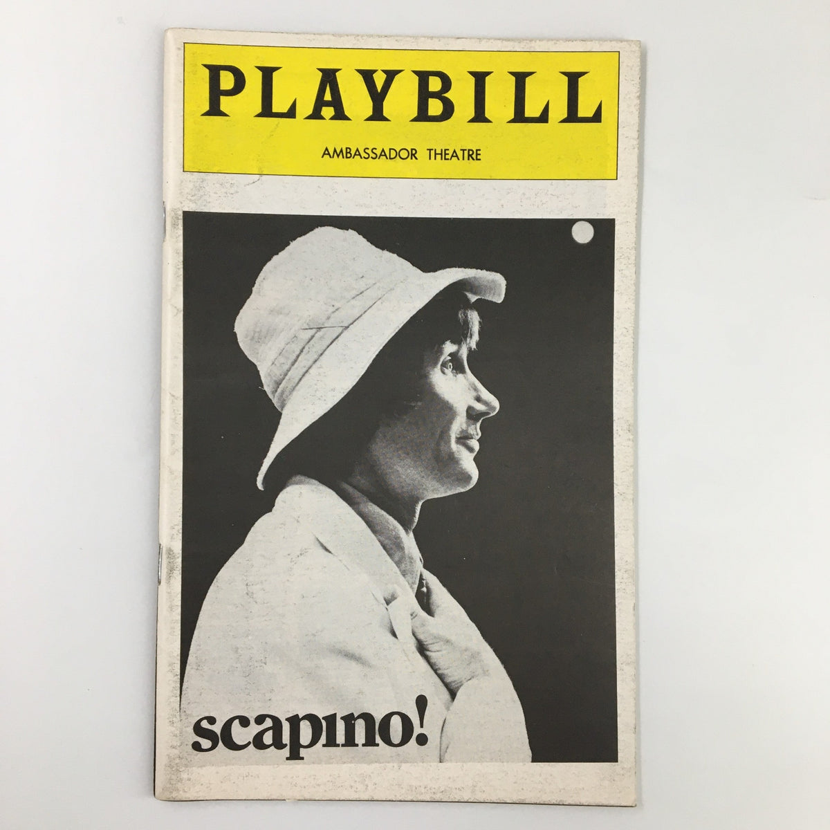 1974 Playbill for Scapino featuring Jim Dale at Ambassador Theatre, showcasing a profile image of a woman wearing a hat.