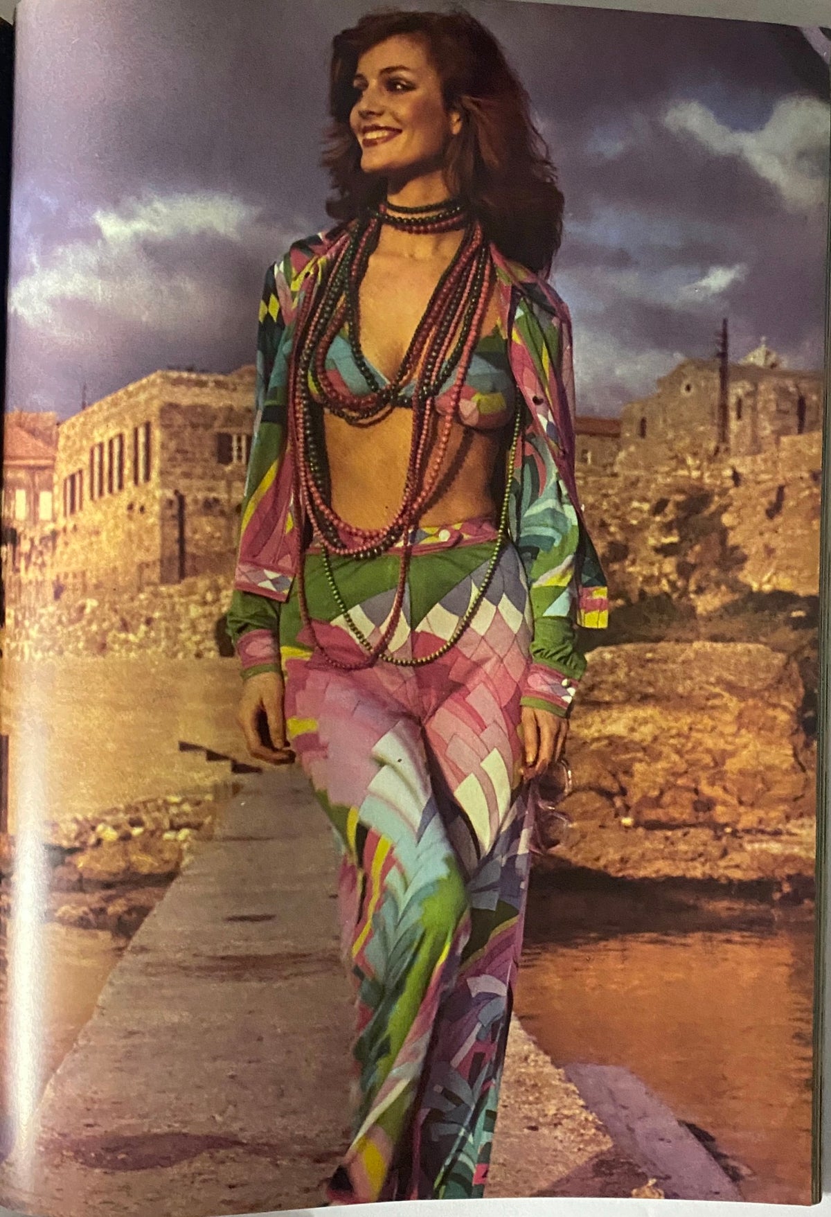 Vogue Paris Magazine May 1973 Jane Birkin Cover showcasing a colorful fashion photograph of a model wearing vibrant 70s attire with a picturesque background, representing the era's bold style.
