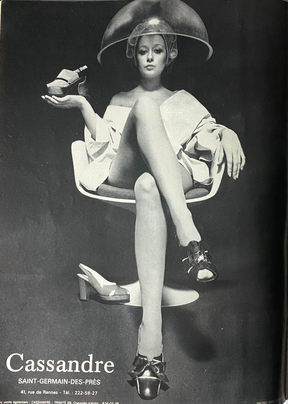Vogue Paris Magazine February 1972 Catherine Deneuve Cover with a model showcasing stylish shoes, wearing a hair dryer cap and an elegant outfit.