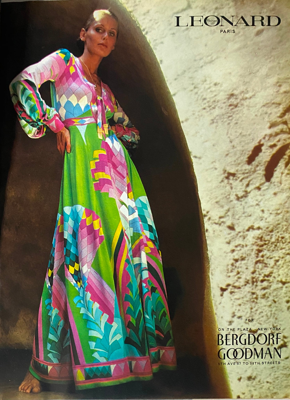 Vogue Magazine December 1972 Cher Cover featuring a model in a vibrant floor-length Leonard Paris dress with a striking pattern, illustrating 1970s fashion.