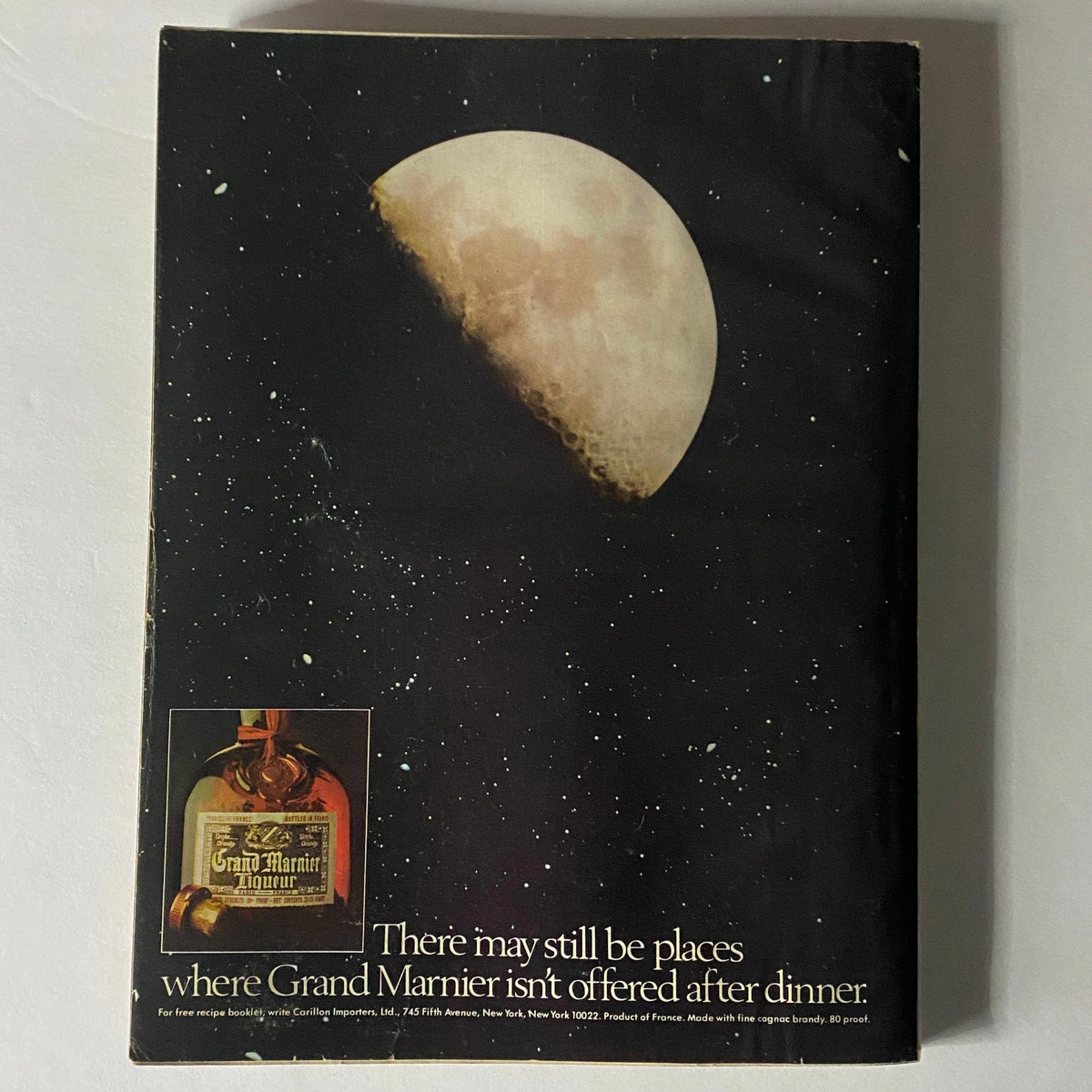 Vogue Magazine February 1978 featuring Patti Hansen on the cover, depicting an advertisement for Grand Marnier with an artistic image of the moon and a bottle of the liqueur, emphasizing its elegance.