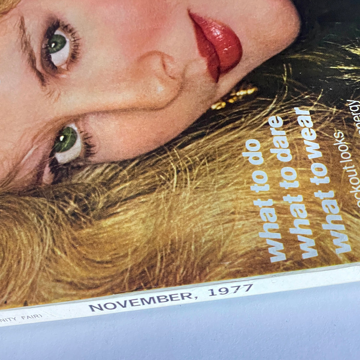 Close-up image of the Vogue Magazine November 1977 cover showing the model's glamorous look alongside text on fashion advice.