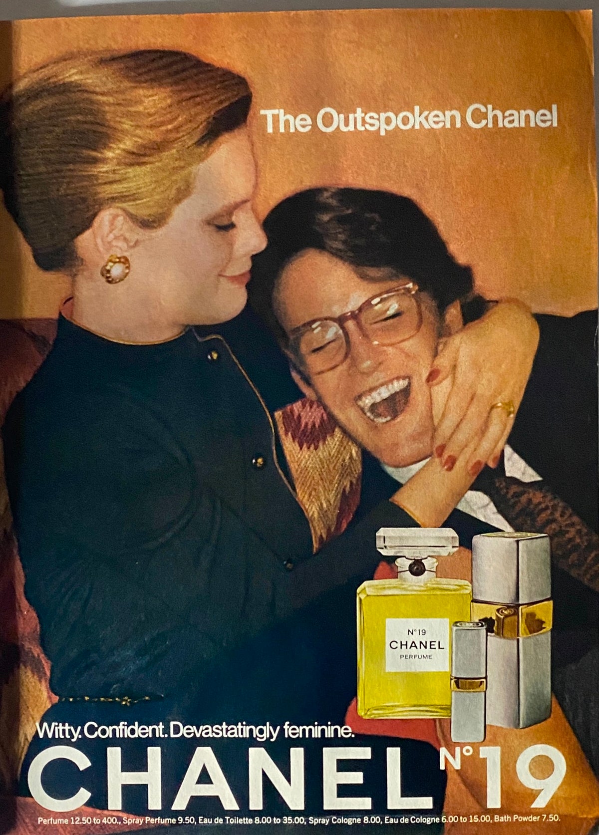 Vogue Magazine February 1977 Chanel N°19 advertisement showcasing the perfume with models embracing, illustrating vintage fashion and beauty aesthetics.