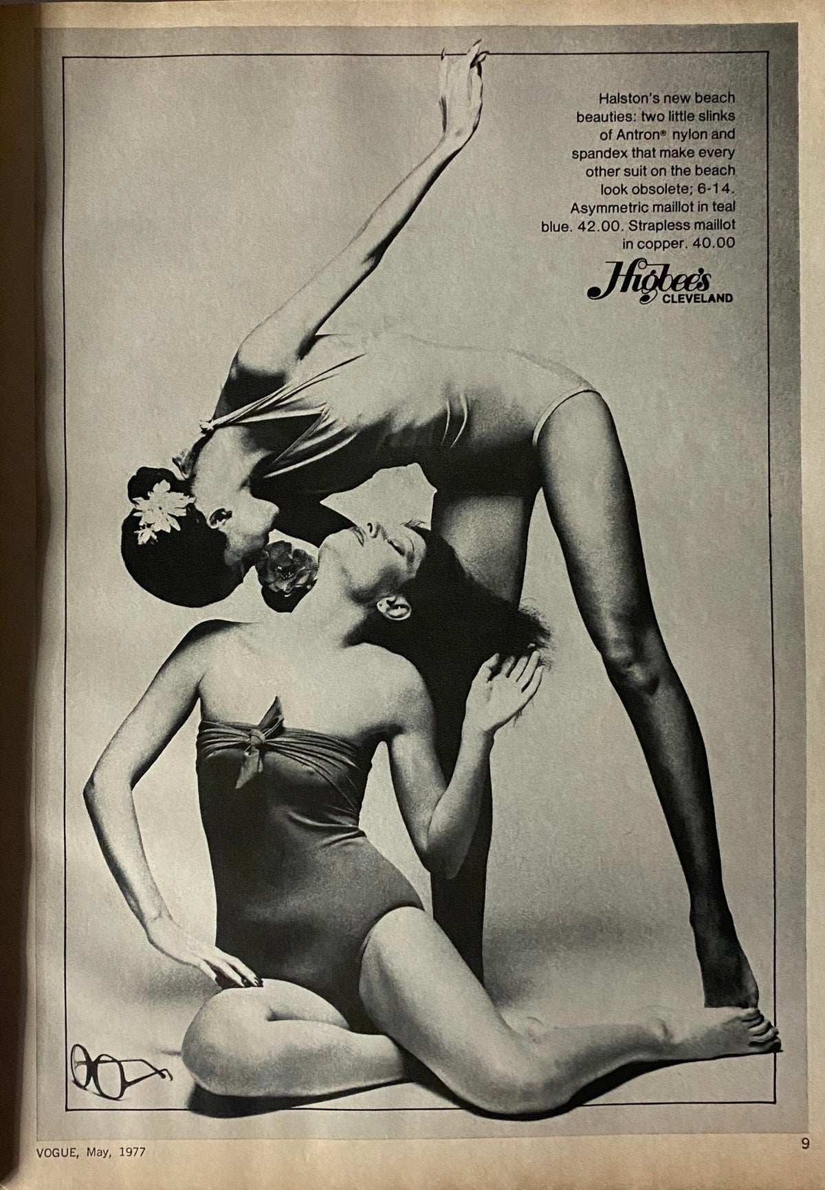 Vogue Magazine May 1977 advertisement featuring two models showcasing Halston beachwear in a striking black and white layout, highlighting fashion trends.