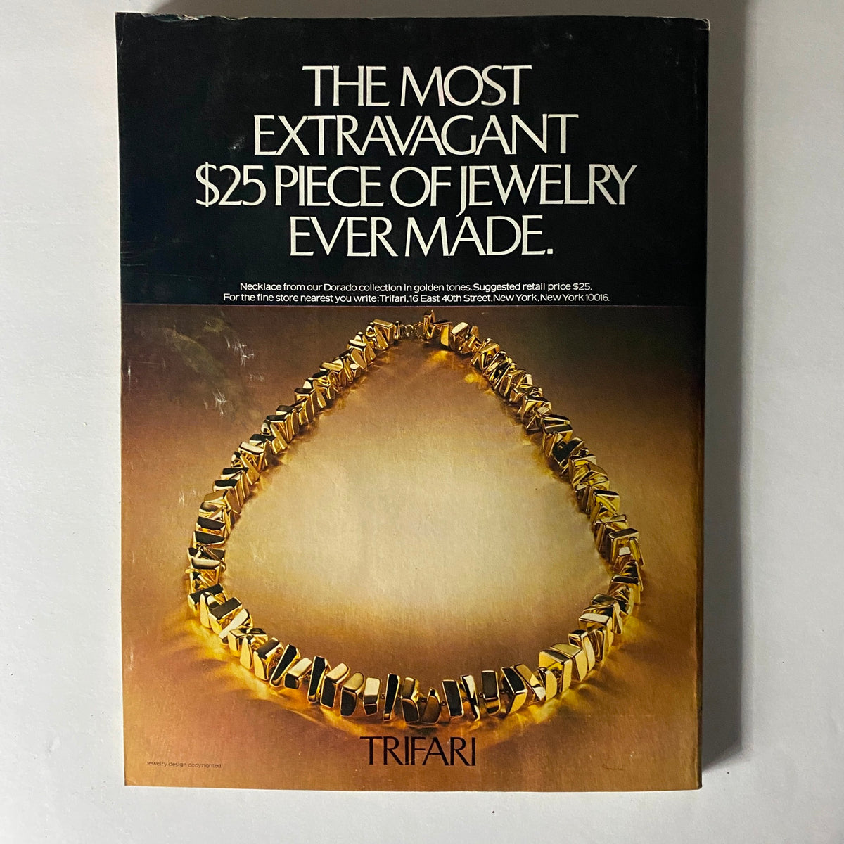 Vintage advertisement featuring the Trifari necklace, described as 'The Most Extravagant $25 Piece of Jewelry Ever Made,' promoting a golden-toned jewelry piece from the Dorado collection, alongside the Vogue Magazine March 1977 Patti Hansen cover.