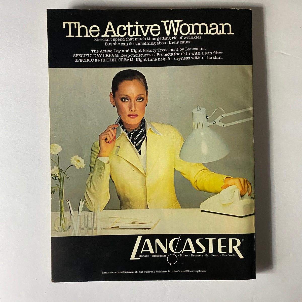 Vogue Magazine Fall/Winter 1978-1979 showcasing an advertisement for Lancaster skincare, featuring a professional model in a bright yellow suit, highlighting skincare products for the active woman.