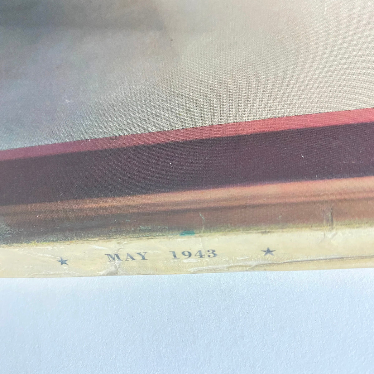 The bottom corner of Mademoiselle Magazine May 1943 displaying the publication date, May 1943, showcasing its historical significance.