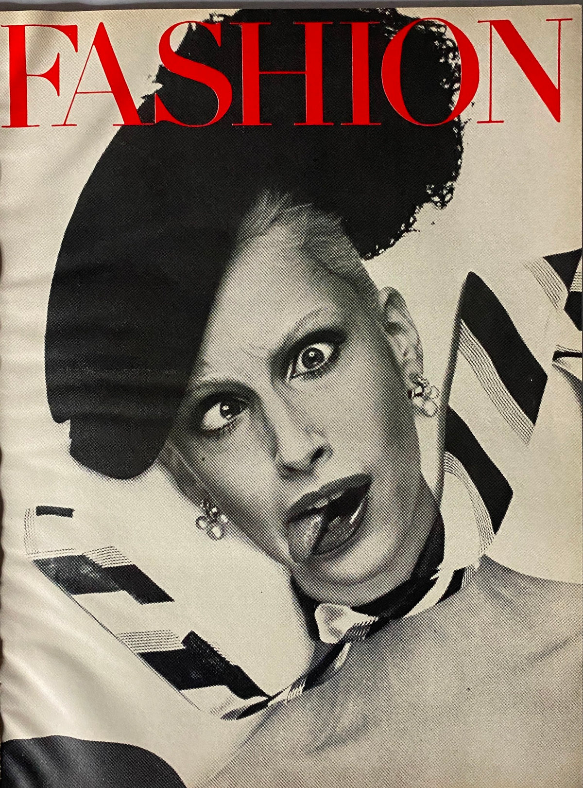Fashion magazine cover with bold graphics depicting a model with striking expression, presenting a vibrant artistic style related to the 1970s aesthetics.