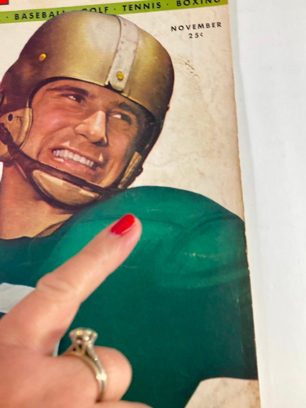Close-up of the cover of VTG Sport Magazine November 1947 Vol 3 #5, featuring Johnny Lujack, emphasizing the vintage design and detailing of the helmet and jersey.