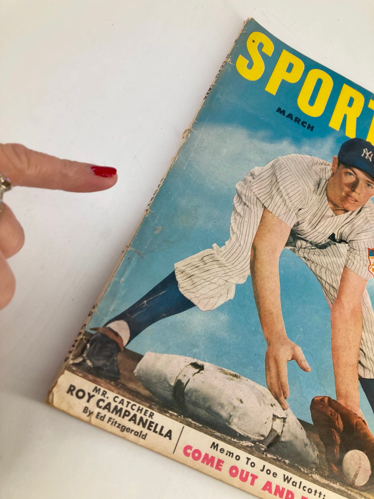 Close-up view of the VTG Sport Magazine March 1952 featuring Gil McDougald's cover with emphasis on minor wear and historical value.