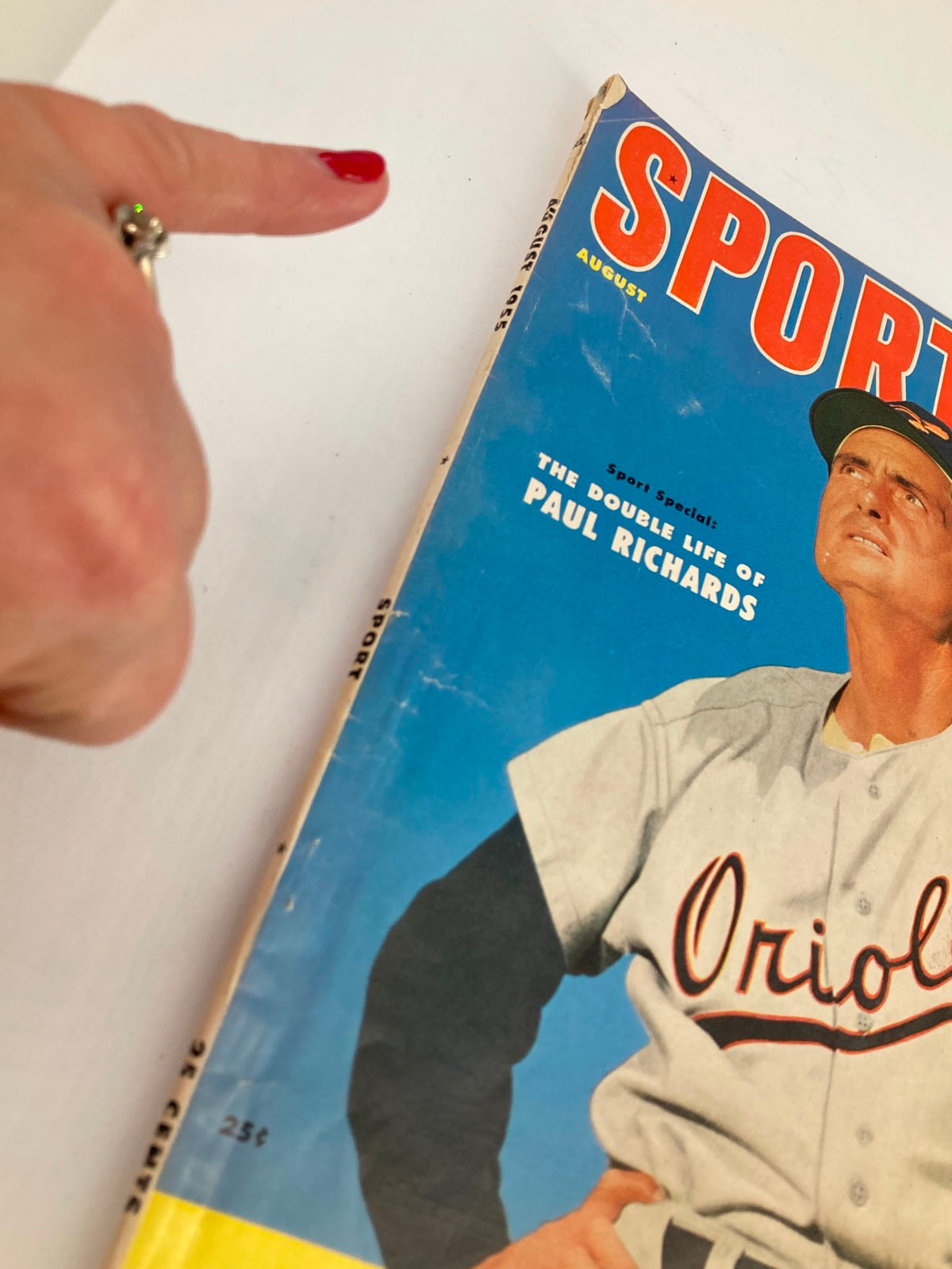 Detail of the VTG Sport Magazine August 1955 cover, highlighting the title 'The Double Life of Paul Richards' with a focus on an individual pointing at the magazine.