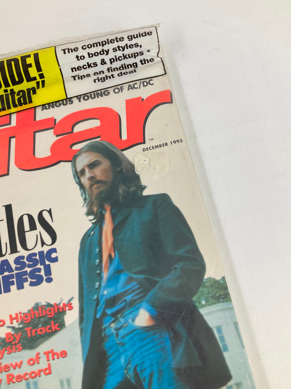Close-up view of the Guitar Magazine December 1995 cover, focusing on a section highlighting The Beatles and '25 Classic Riffs', along with additional tips for guitar buying.