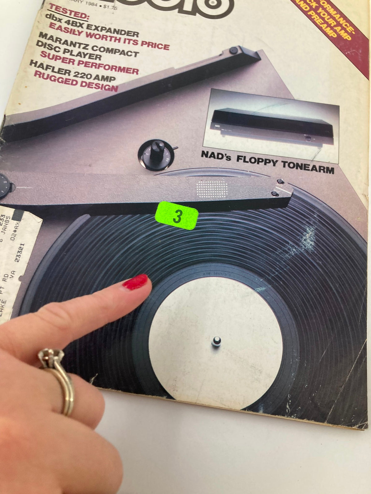 Vintage Audio Magazine February 1984 cover featuring Nad 'Floppy' Tonearm and 5120 Turntable with an illustrative emphasis on a vinyl record and a hand pointing at it.