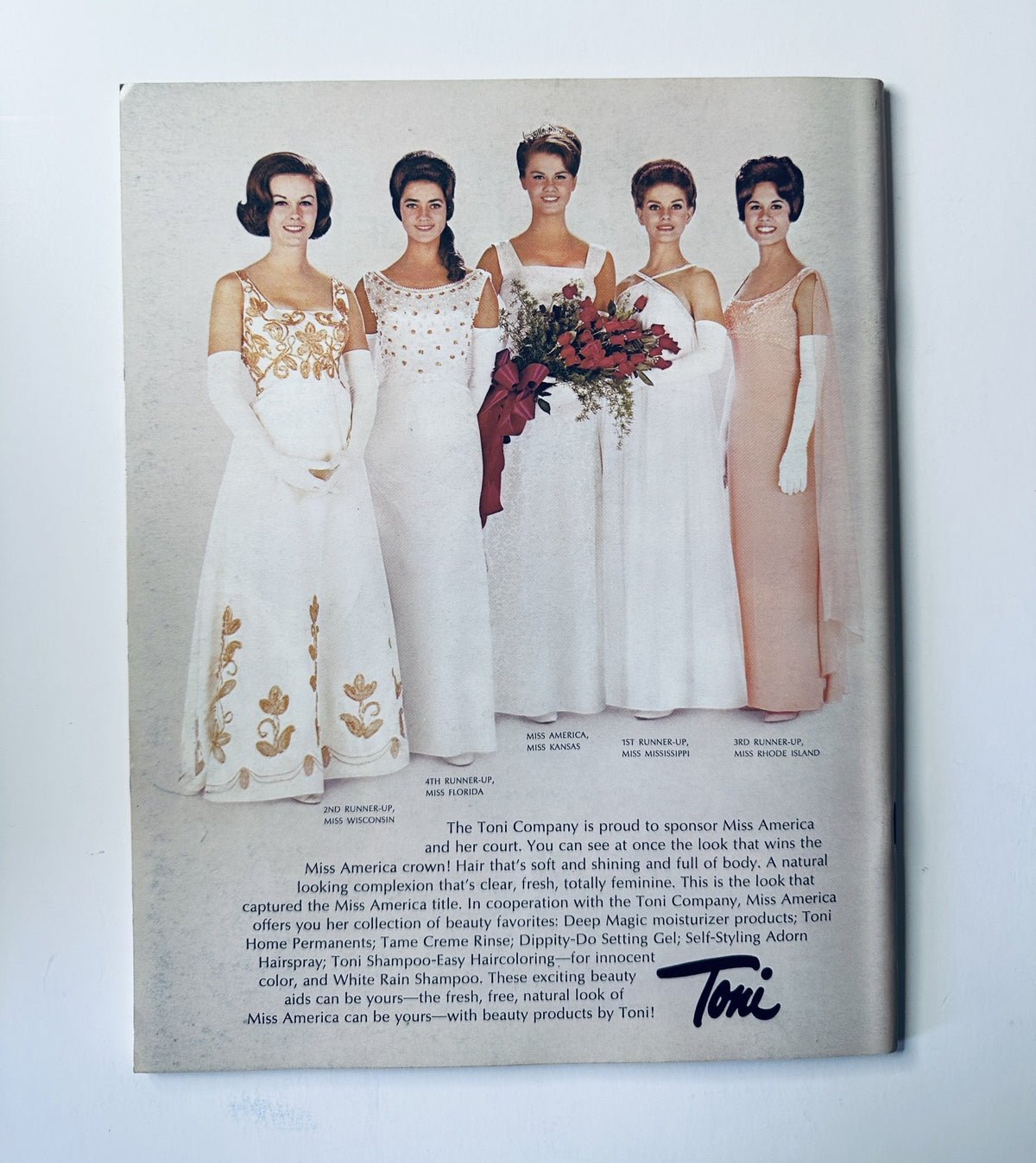 Back cover of the 1968 Miss America Pageant magazine, showcasing contestants in evening gowns sponsored by the Toni Company, emphasizing the beauty and elegance of Miss America candidates.