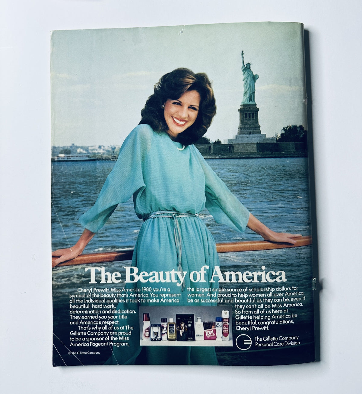 Cheryl Prewitt, Miss America 1980, featured on the cover of The 1980 Miss America Pageant Magazine Program, posing in front of the Statue of Liberty with the title "The Beauty of America". The magazine highlights her role in promoting the Miss America Pageant.