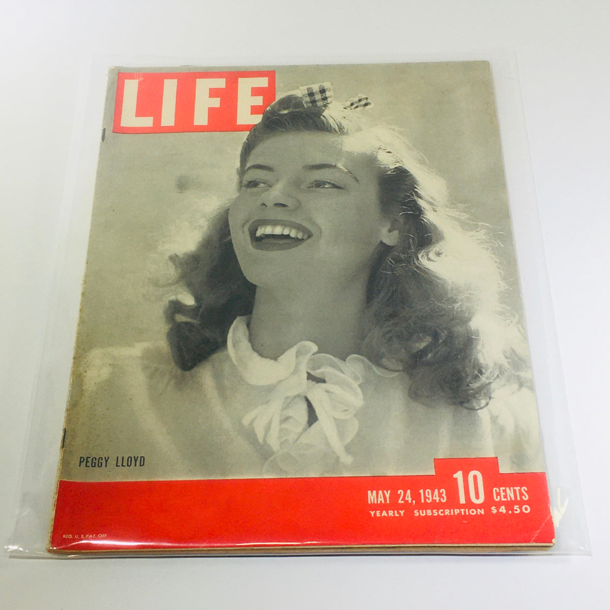 Vintage Life Magazine cover featuring Peggy Lloyd, dated May 24, 1943. The cover highlights Peggy Lloyd's smiling portrait, with prominent red text indicating the magazine title 'LIFE' and issue details about the St Nazaire Raid.