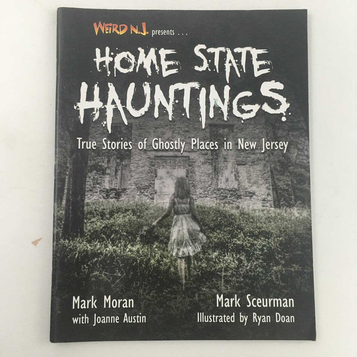 Cover of Weird N.J. Magazine September 2013 featuring 'Home State Hauntings' with the title prominently displayed, depicting a ghostly figure in a white dress against a haunting backdrop, showcasing true stories of ghostly places in New Jersey.