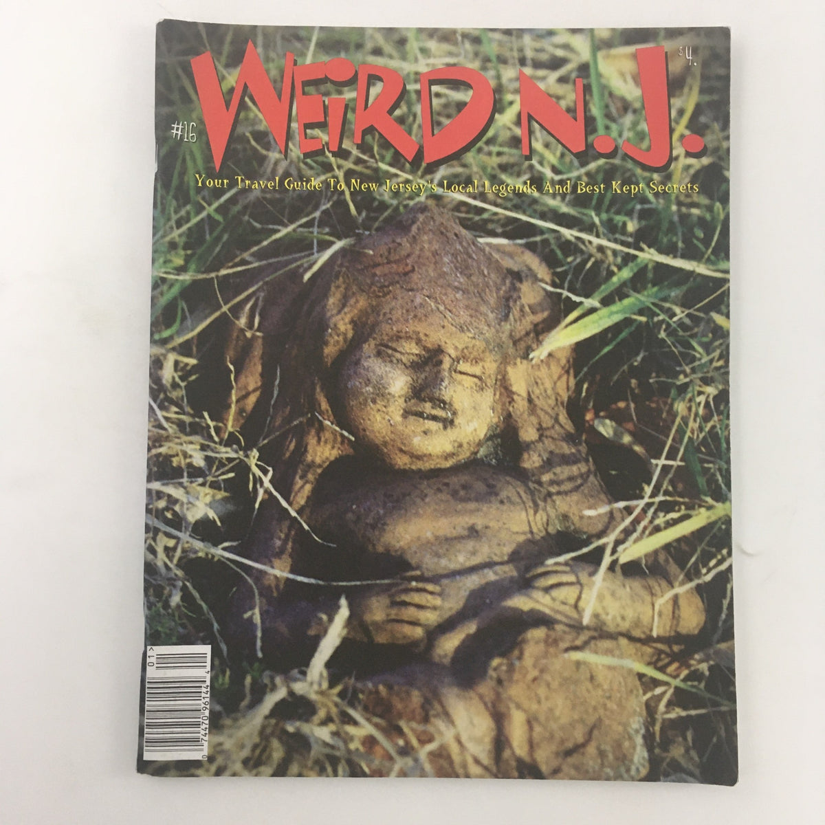 Cover of Weird N.J. Magazine 2001 #16, featuring a unique image of a clay figure lying in grass, highlighting local legends and best-kept secrets of New Jersey.