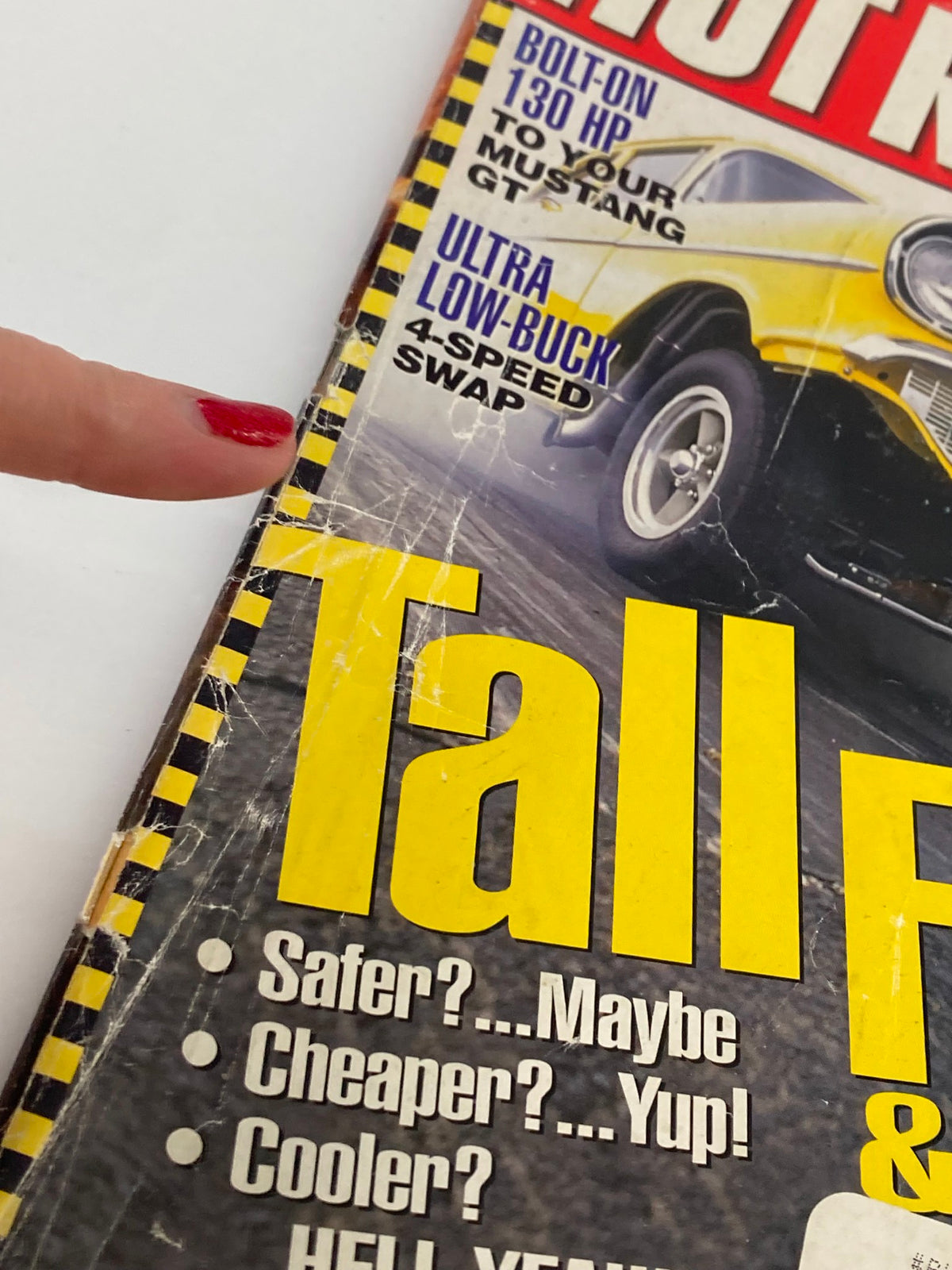Close-up of the Hot Rod Magazine August 2000 cover detailing the text 'Safer?...Maybe Cheaper?...Yup! Cooler?...HELL YEAH!' highlighting performance features.