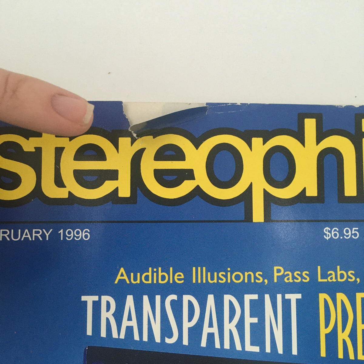 Close-up view of the Stereophile Magazine February 1996 cover showing minor wear and tear. The title includes discussions on car audio, transparent preamps, and other audio reviews.