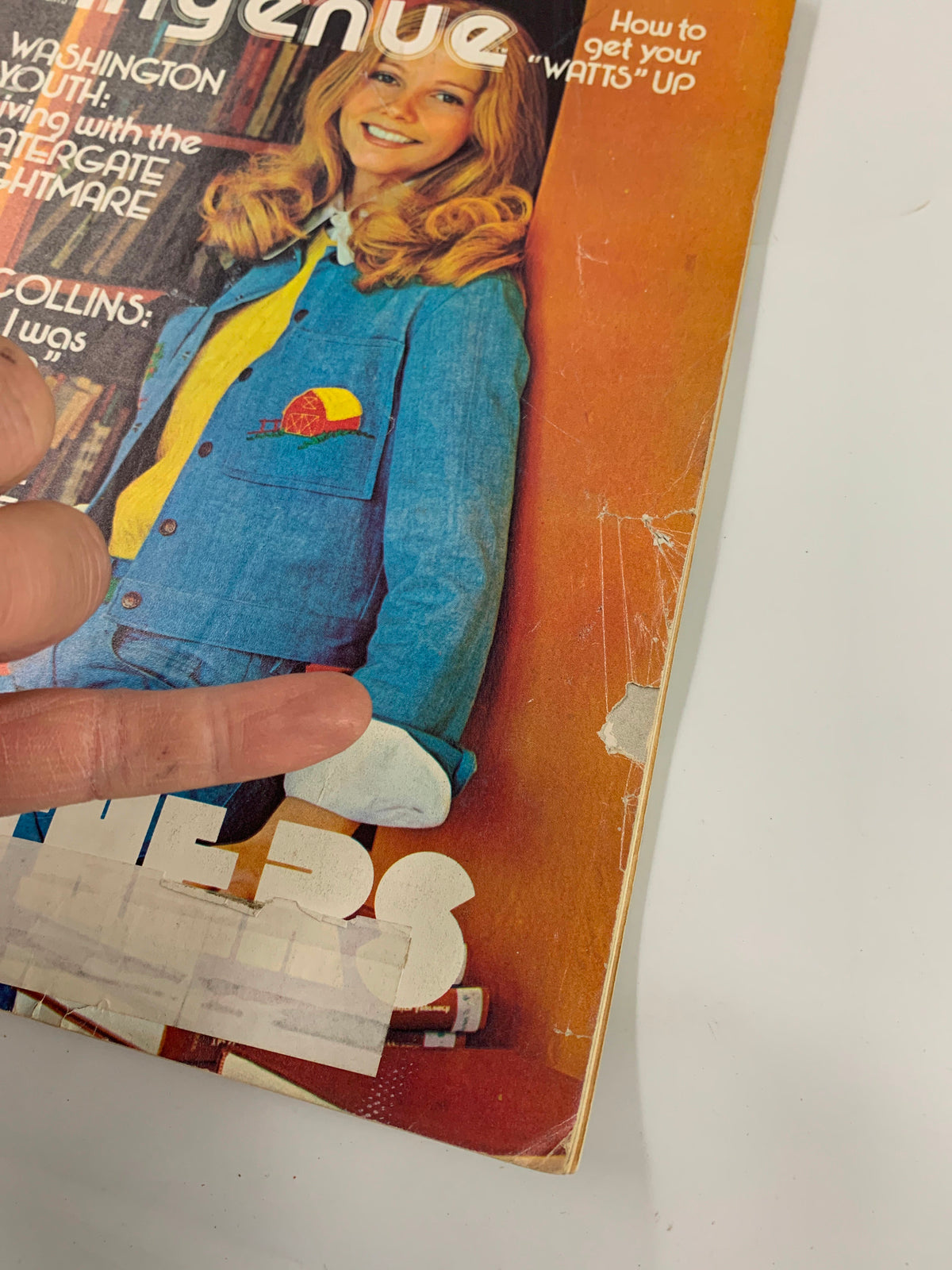 Close-up of the cover of the VTG New Ingenue Magazine February 1974, highlighting the smiling model and text related to Judy Collins and Jim Croce, with visible wear consistent with its vintage status.