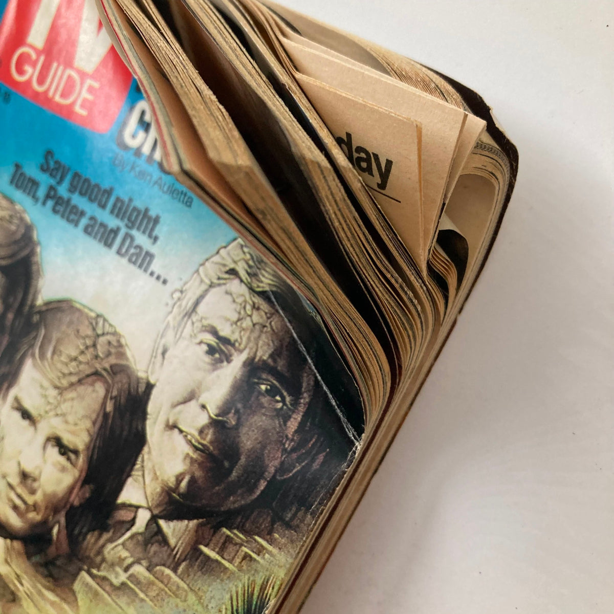 Close-up view of the TV Guide Magazine from November 9, 1991, highlighting creased pages and iconic cover art featuring the Olsen twins. A glimpse into vintage television history.