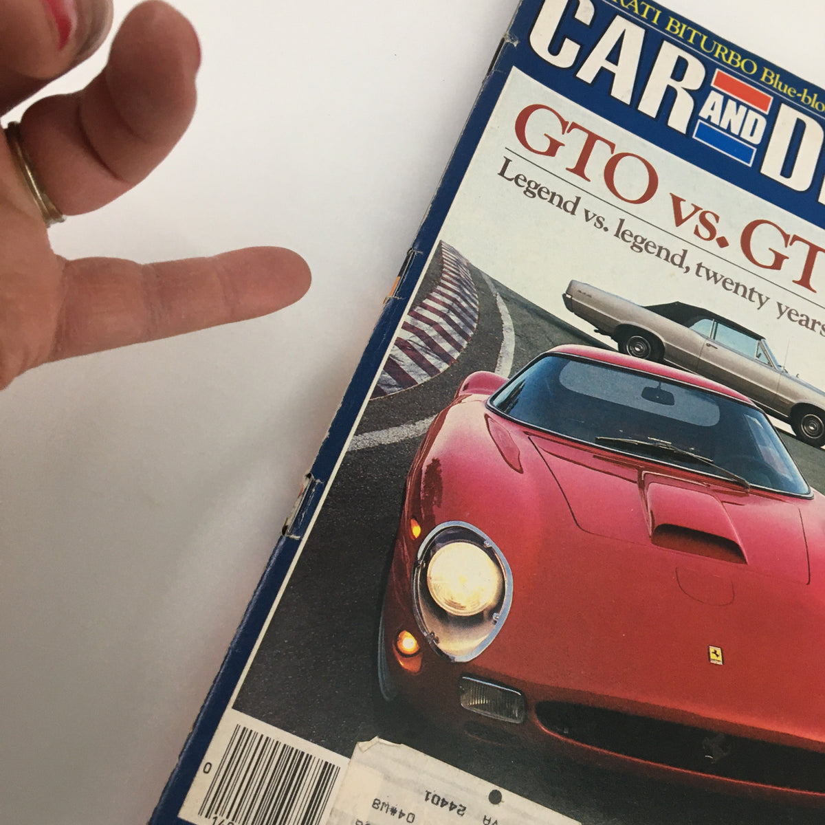 Side view of the April 1984 Car and Driver Magazine cover, focusing on GTO vs GTO! and a classic design featuring a red sports car and another vintage automobile.
