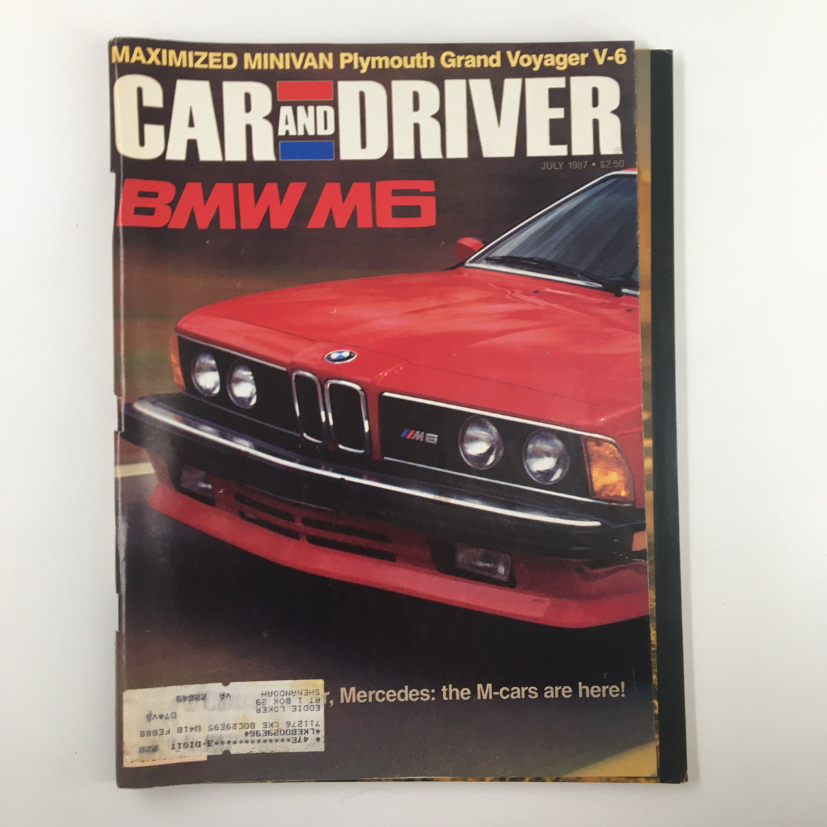 Cover of Car and Driver Magazine from July 1987 featuring the title 'MAXIMIZED MINIVAN Plymouth Grand Voyager V-6' with a red BMW M6 car prominently displayed.