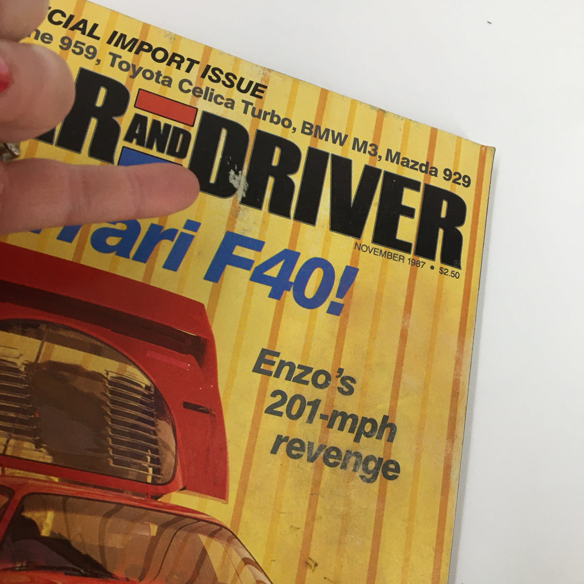 Close-up of the Car and Driver Magazine November 1987 cover showing Ferrari F40, BMW M3, and Mazda 929 with the text 'Enzo’s 201-mph revenge'.