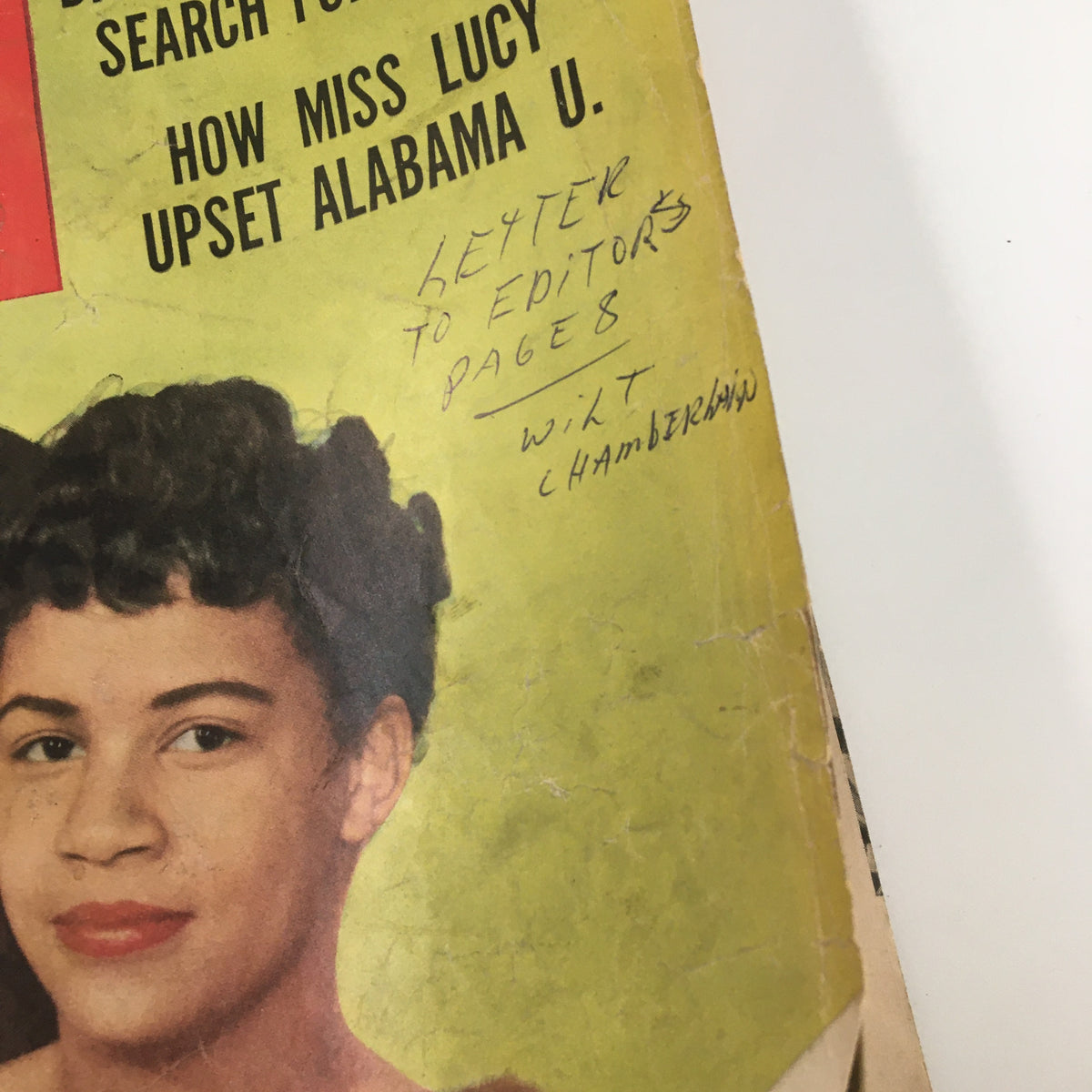 Close-up of a handwritten note on the VTG Ebony Magazine March 1957 cover reading 'LETTER TO EDITORS PAGE 8' along with the name 'WILT CHAMBERLAIN'.
