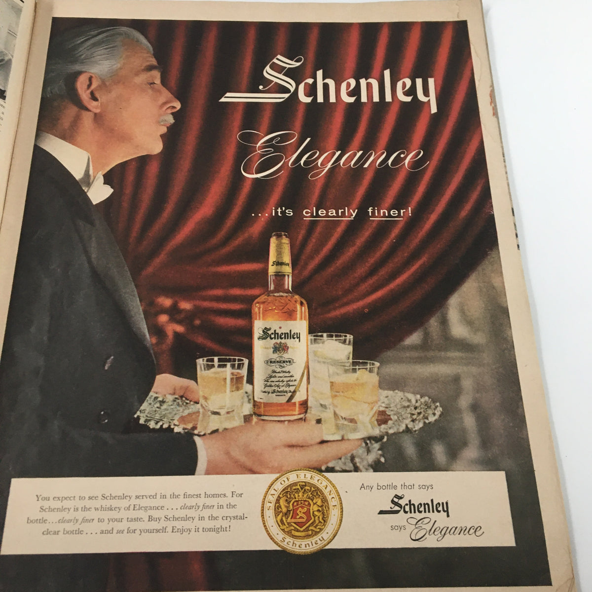 Vintage advertisement for Schenley whiskey in the March 1957 issue of Ebony Magazine, emphasizing elegance and refinement in beverage choices.