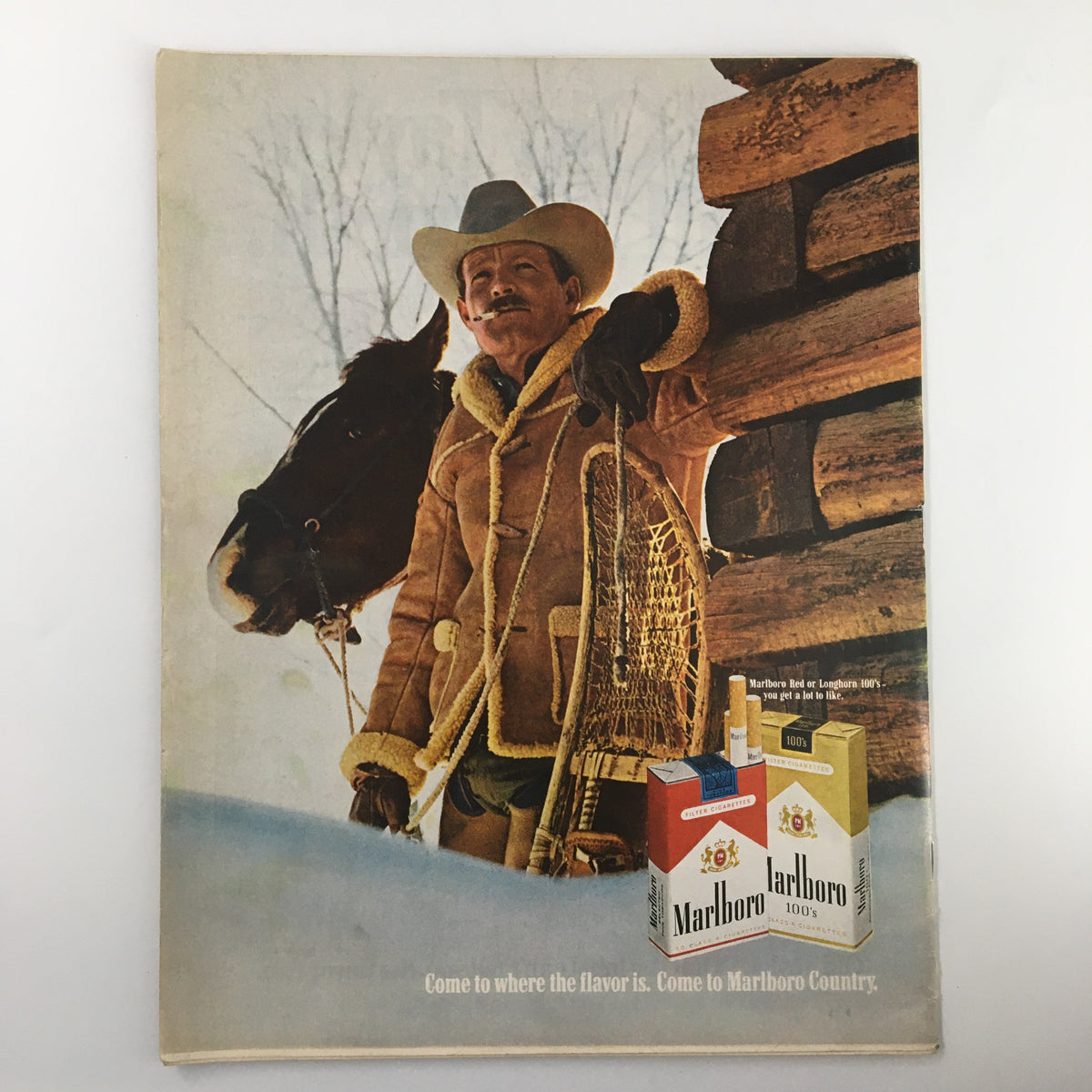 Advert by Marlboro from a vintage magazine, featuring a cowboy with a horse, promoting Marlboro cigarettes, in the context of December 19 1969 VTG Life Magazine.
