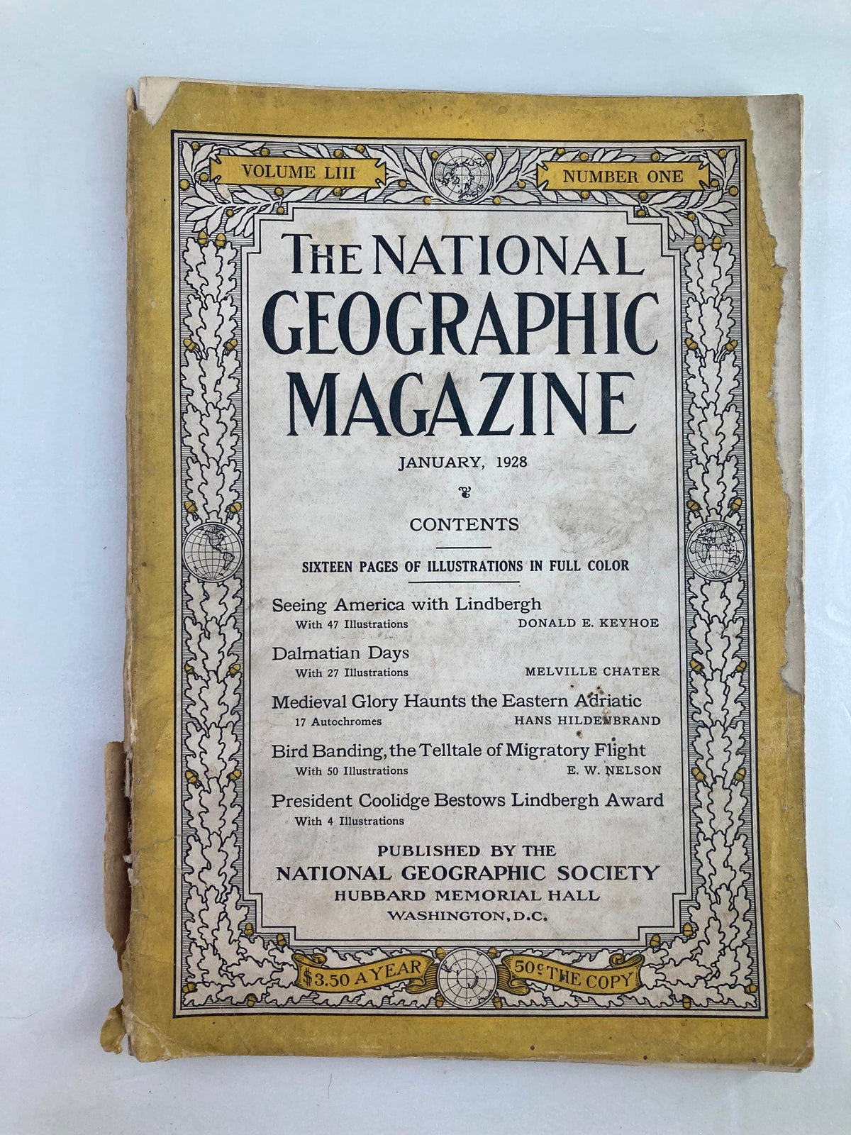 Vintage National Geographic Magazine from January 1928 featuring bird banding, with decorative cover design and contents listed including articles about Lindbergh and Dalmatian Days.