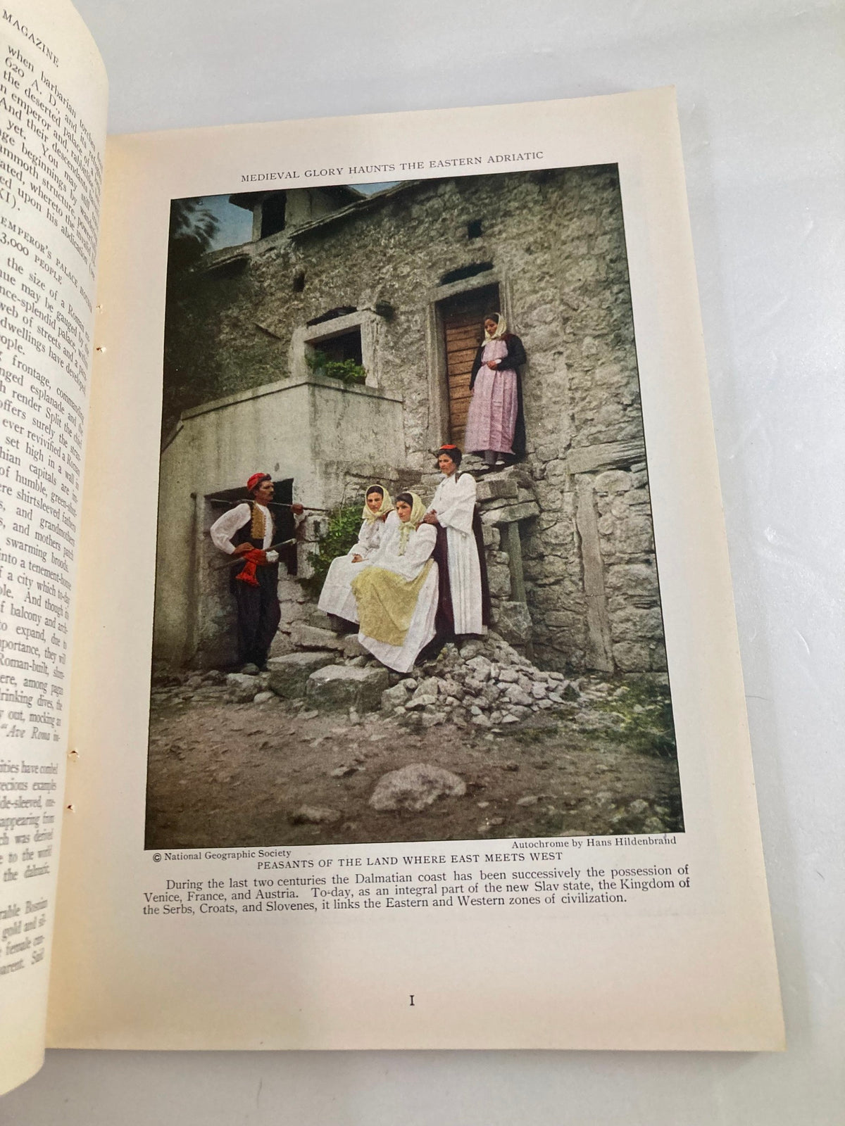 Photograph featured in The National Geographic Magazine January 1928 showing traditional attire in a historical setting, illustrating the cultural richness of the Eastern Adriatic region.