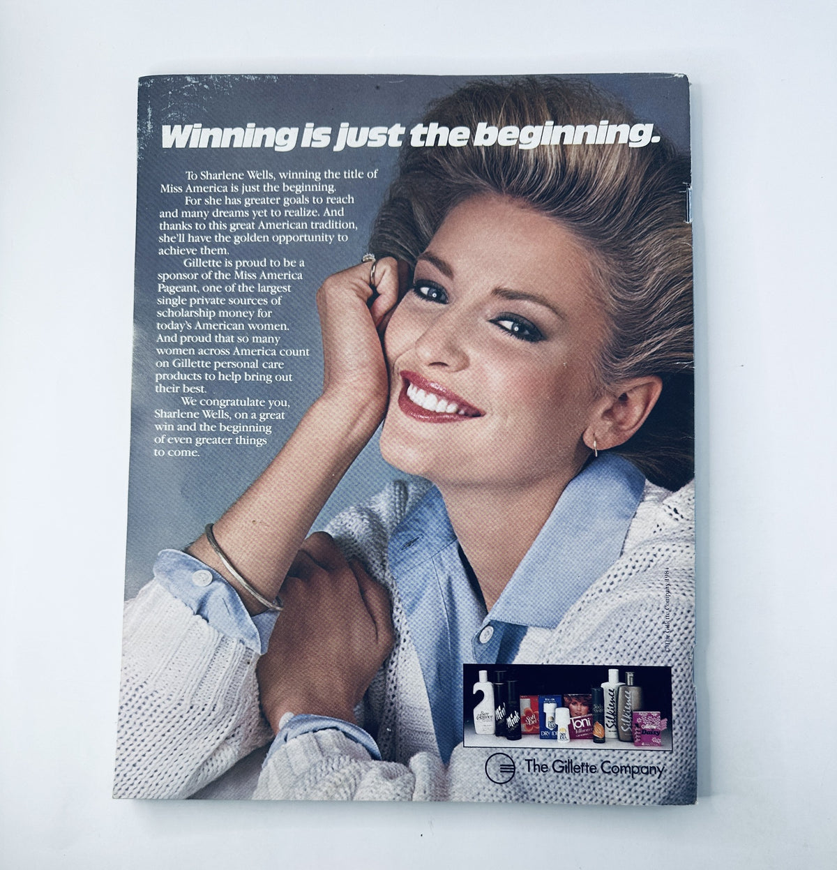 Back cover of The 1985 Miss America Pageant Magazine Official Program featuring Sharlene Wells with a quote about winning and sponsorship. The magazine showcases advertisements by The Gillette Company.