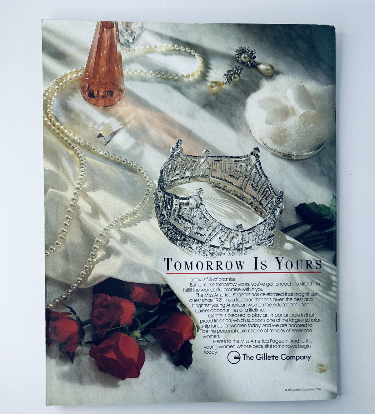 Official program cover of the 1989 Miss America Pageant featuring a sparkling tiara, pearls, roses, and a statement 'Tomorrow Is Yours', highlighting the event’s significance and the influential role of Miss America. The cover design celebrates beauty and ambition.