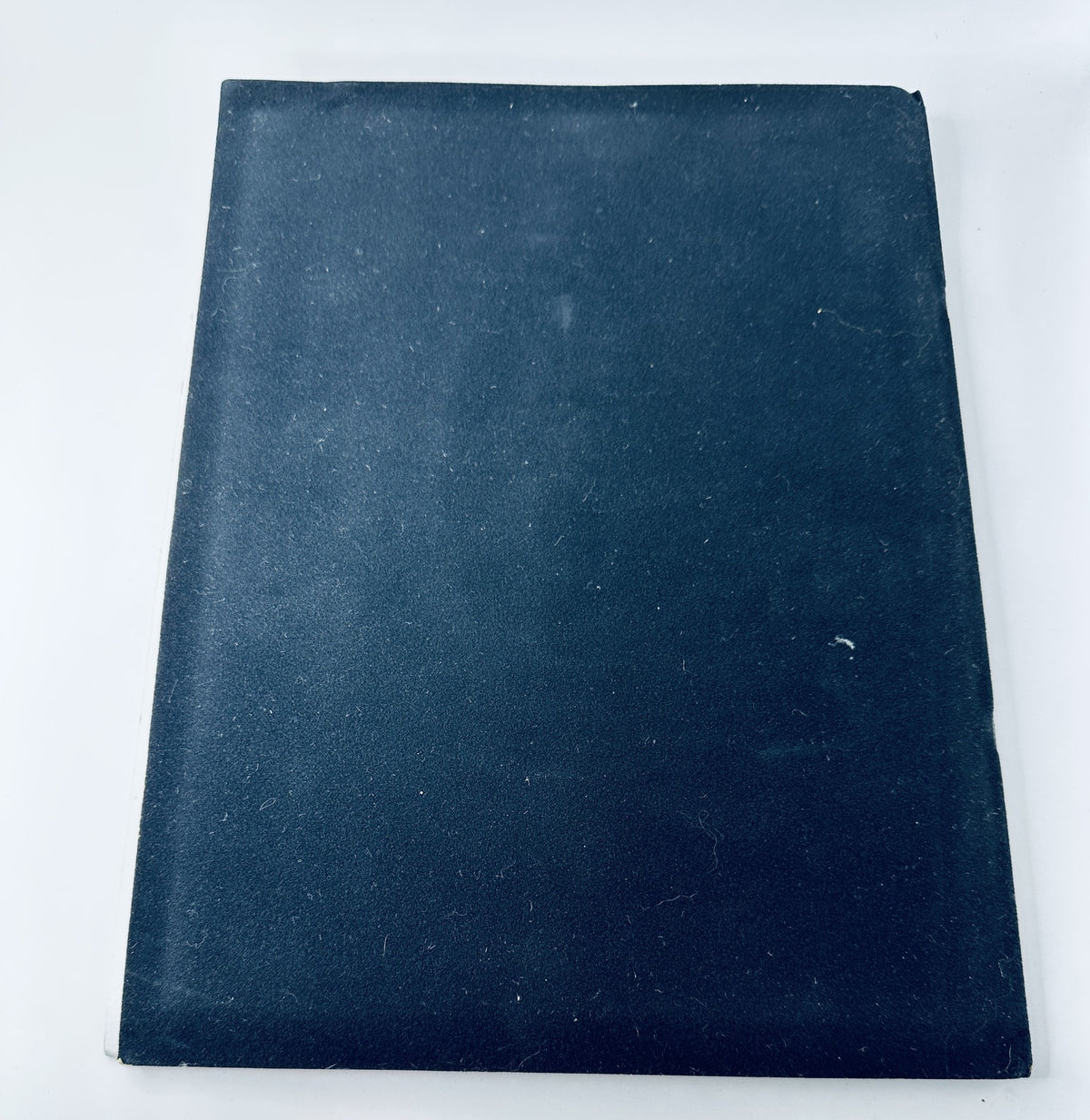 Back cover of Oscar Magazine 56th Annual Academy Awards April 9, 1984, featuring a plain black surface showing signs of age.