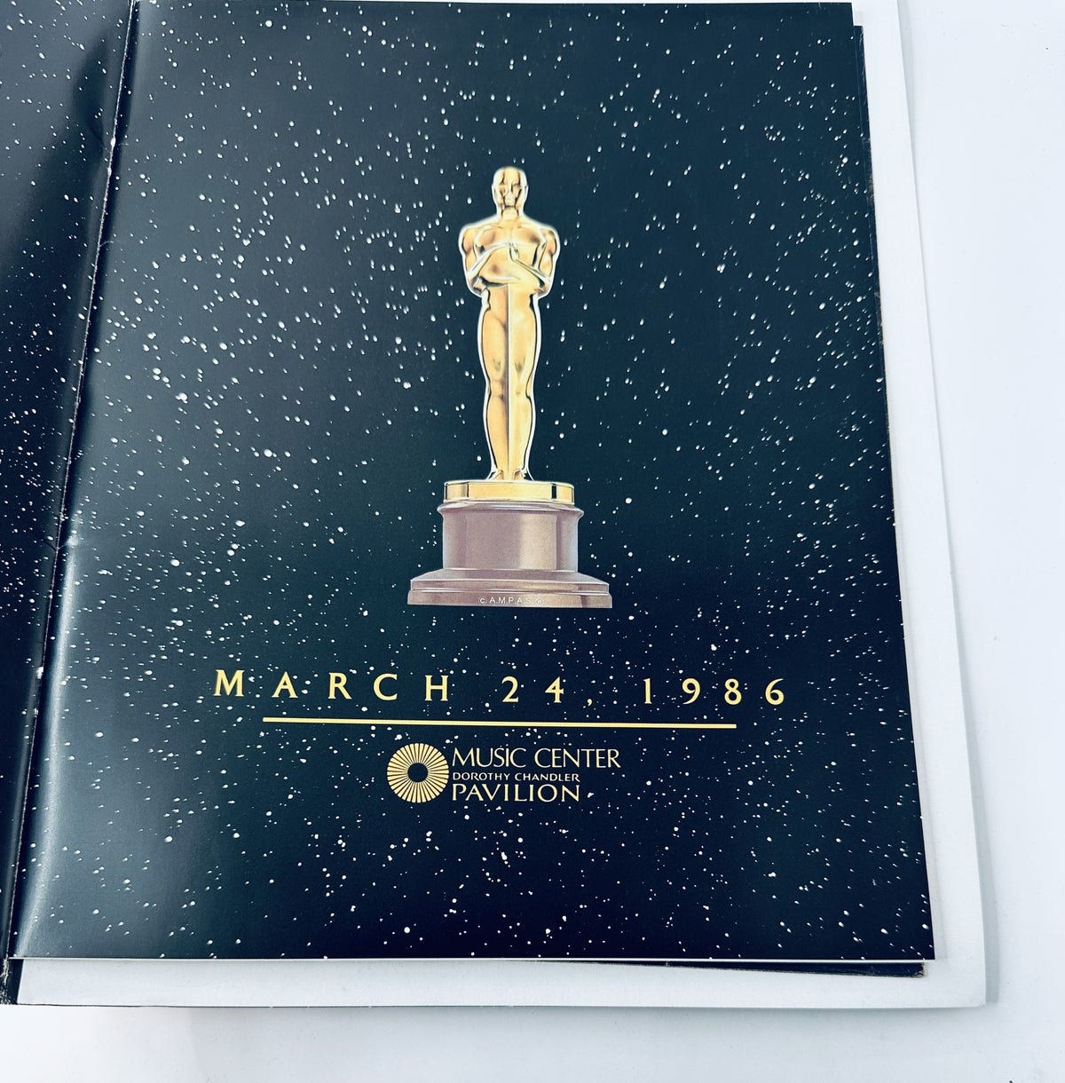 Inside page of the Oscar Magazine 58th Annual Academy Awards 1986 Program showcasing a date and venue details, featuring a golden Oscar statue.