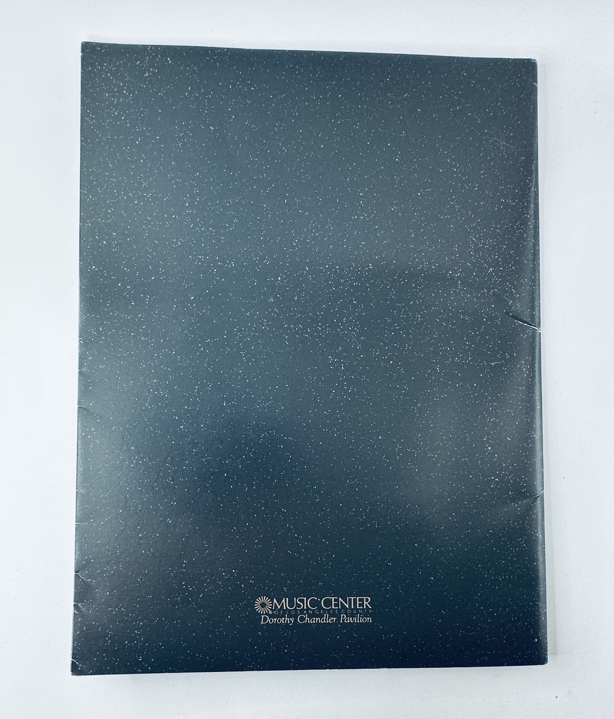 Oscar Magazine 64th Annual Academy Awards 1992 Program back cover featuring the Music Center logo, designed with a starry background and showing signs of wear.
