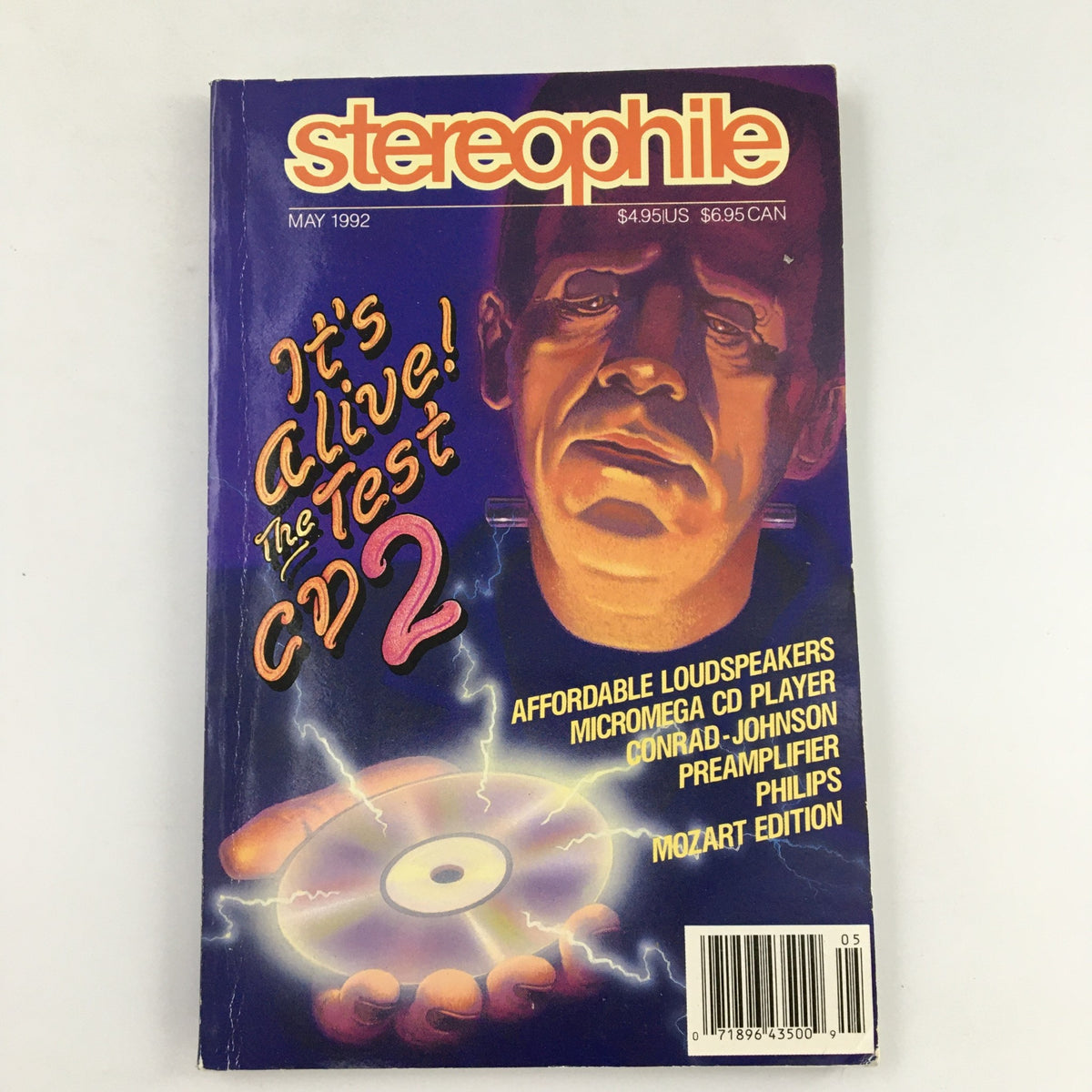 Stereophile Magazine May 1992 edition featuring the Preamplifier Philips Mozart Edition. The cover highlights the theme 'It's Alive! The Test CD2' with a striking illustration and mentions affordable loudspeakers and various audio products. A must-have for audiophiles and vintage magazine collectors.