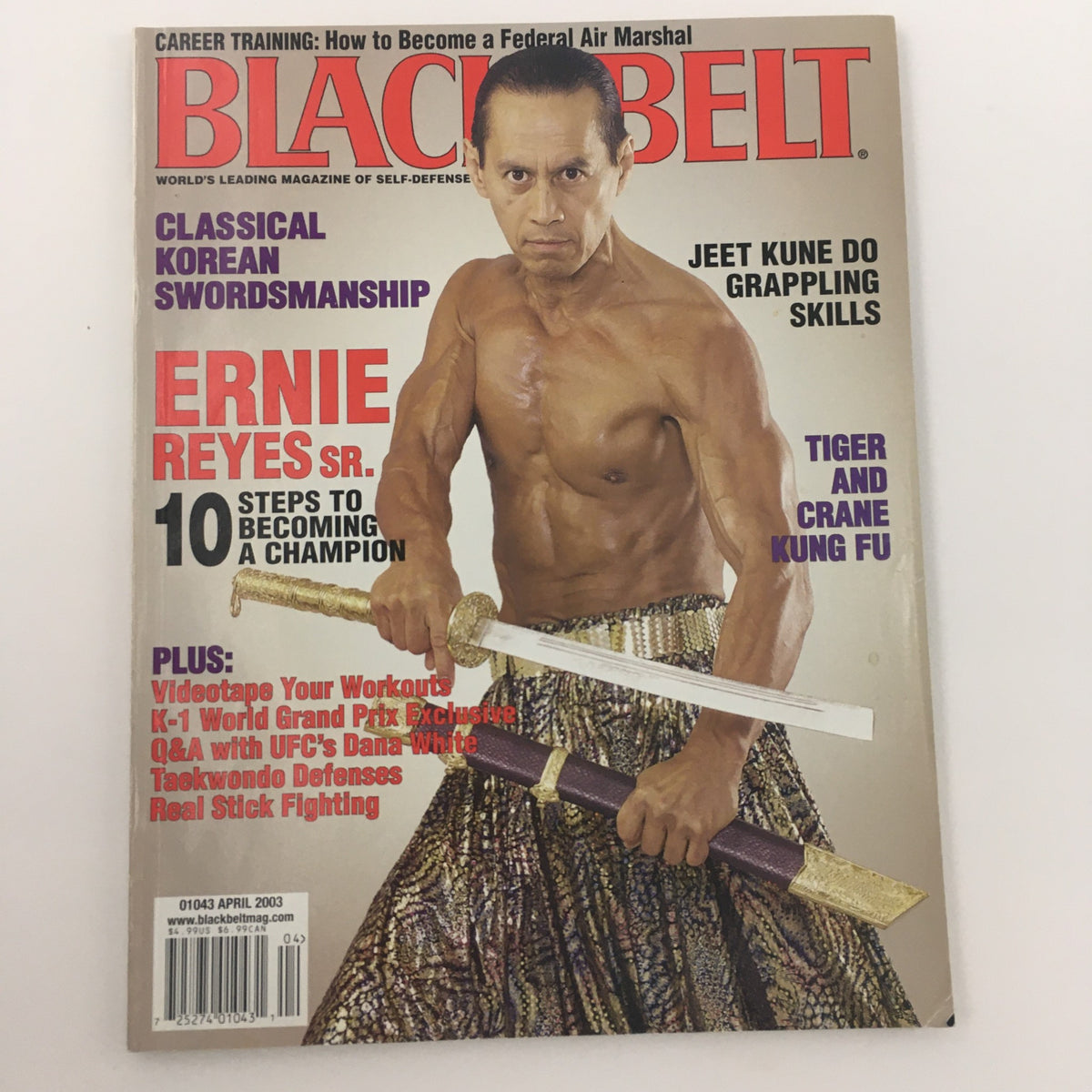 Black Belt Magazine April 2003 cover featuring Champion Ernie Reyes Sr., demonstrating martial arts techniques with a sword, dressed in traditional clothing.