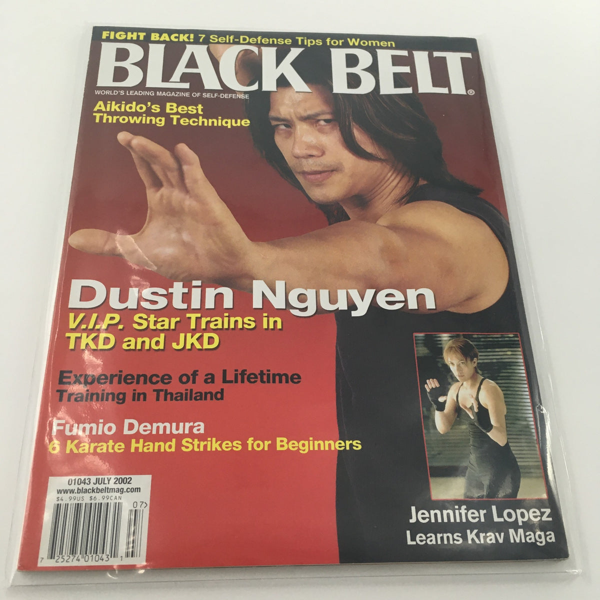 Black Belt Magazine July 2002 featuring Dustin Nguyen on the cover with Jennifer Lopez. The issue discusses self-defense tips, Aikido techniques, and martial arts training.