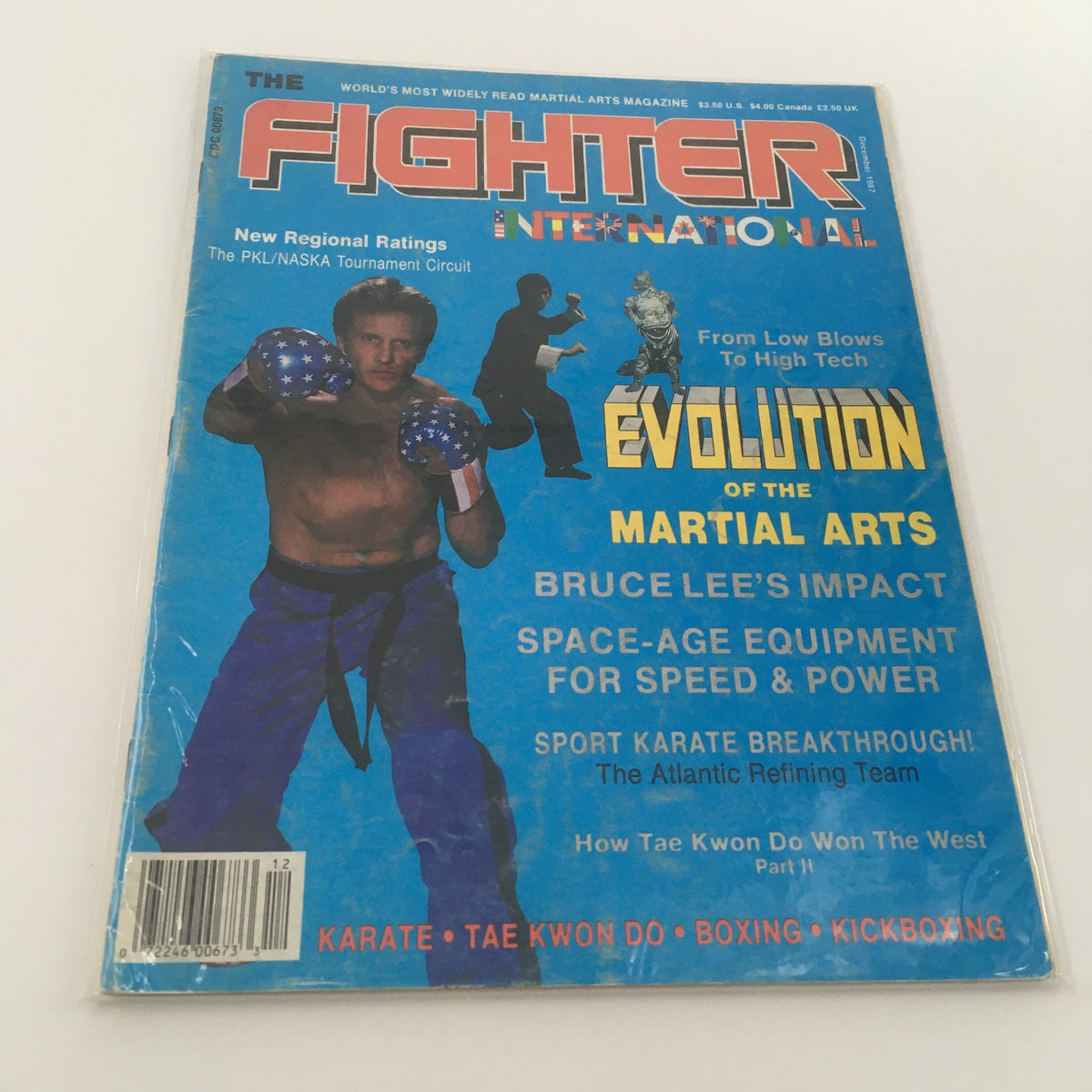 Cover of the VTG Fighter Int'l Magazine December 1987 titled 'Evolution of Martial Arts'. Features a male martial artist in blue boxing gloves, showcasing the influence of Bruce Lee and sporting various martial arts styles.