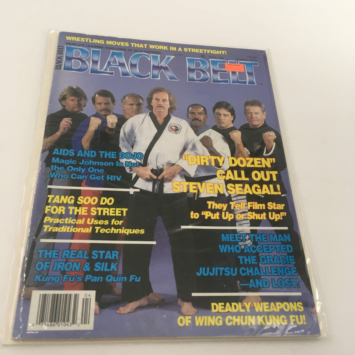 Cover of Black Belt Magazine April 1992 featuring the 'Dirty Dozen Call Out Steven Seagal' article, showcasing a group of martial artists in striking poses.