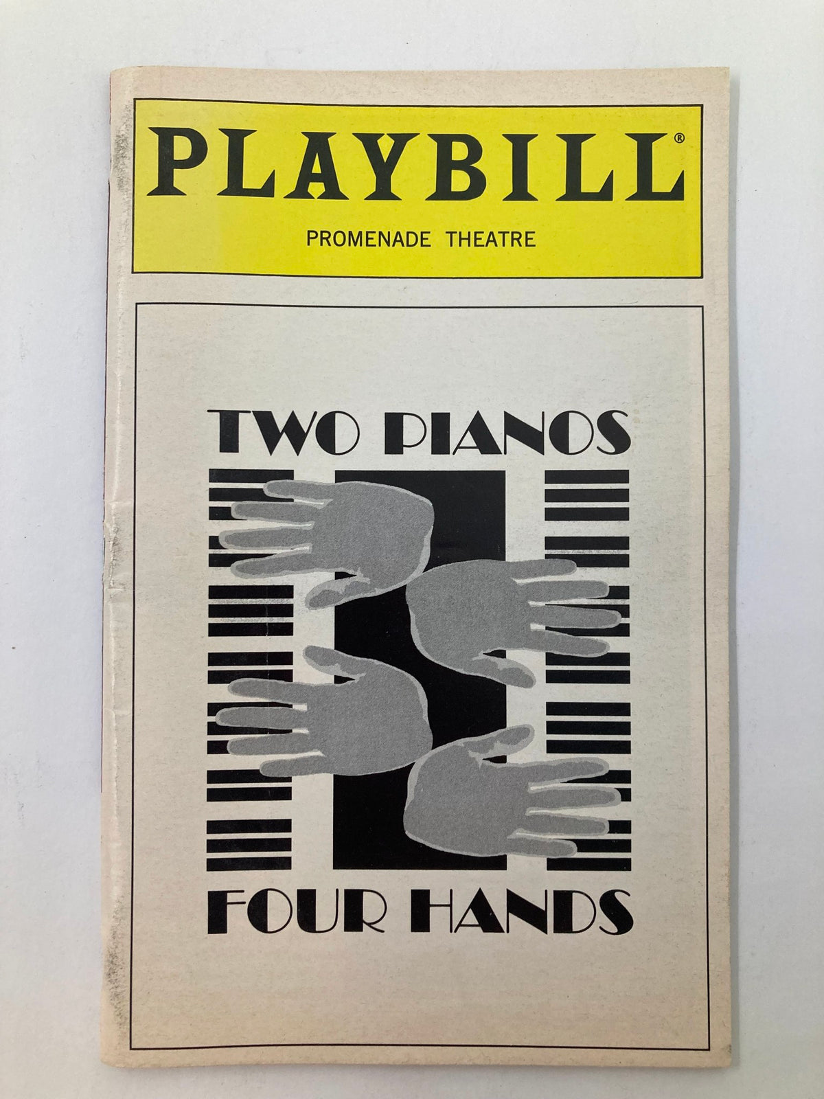 1997 Playbill for 'Two Pianos, Four Hands' at Promenade Theatre featuring iconic graphics with piano hands design.
