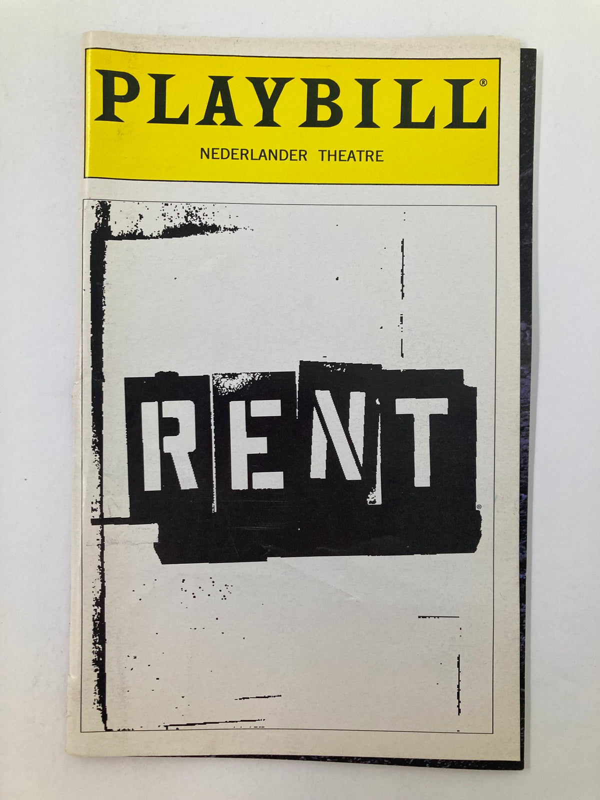 1999 Playbill from Nederland Theatre featuring the musical Rent, showcasing its iconic logo.