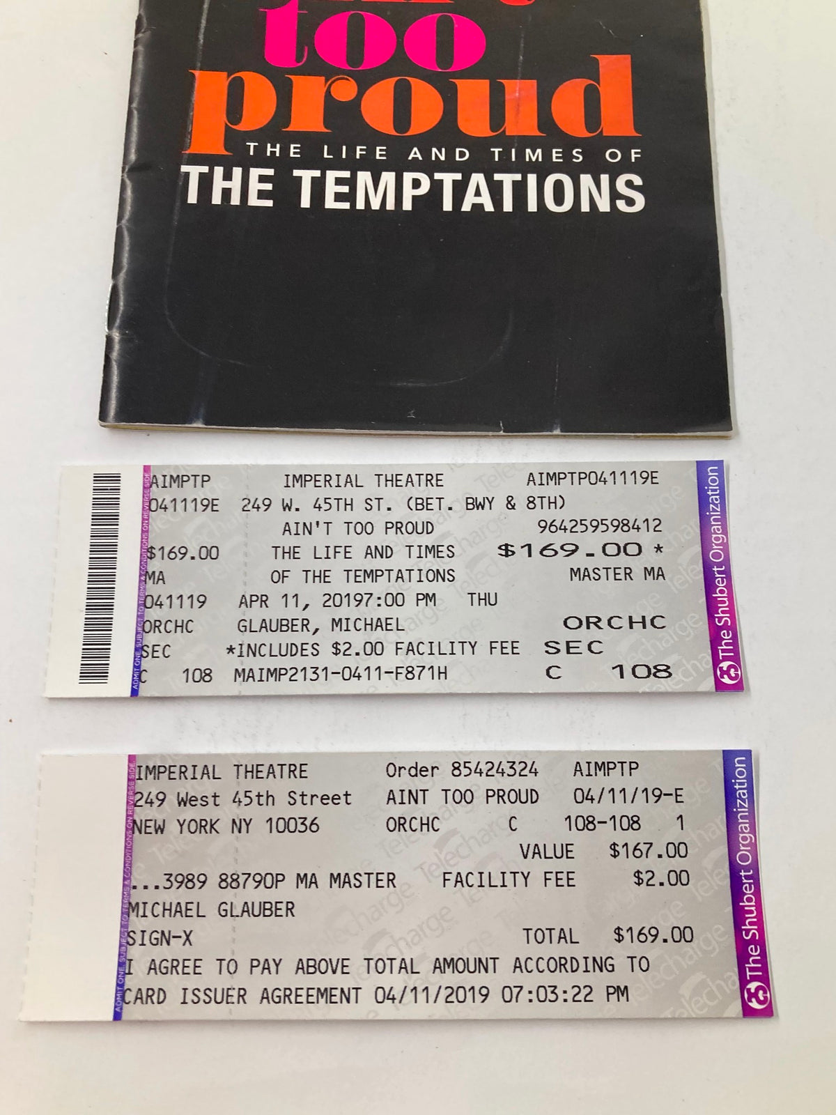 A 2019 Playbill for 'Ain't Too Proud' at the Imperial Theatre, displaying ticket stubs and details of the performance featuring Derrick Baskin and James Harkness.